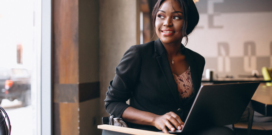 African American Business Woman Working On A Computer In A Bar