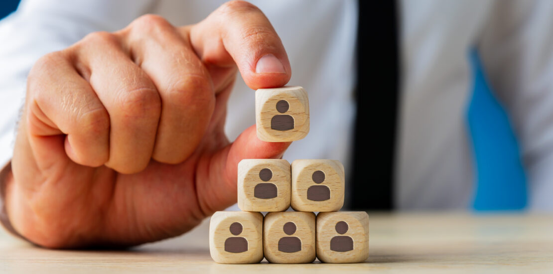 Business Executive Stacking Wooden Dices With People Icons On T
