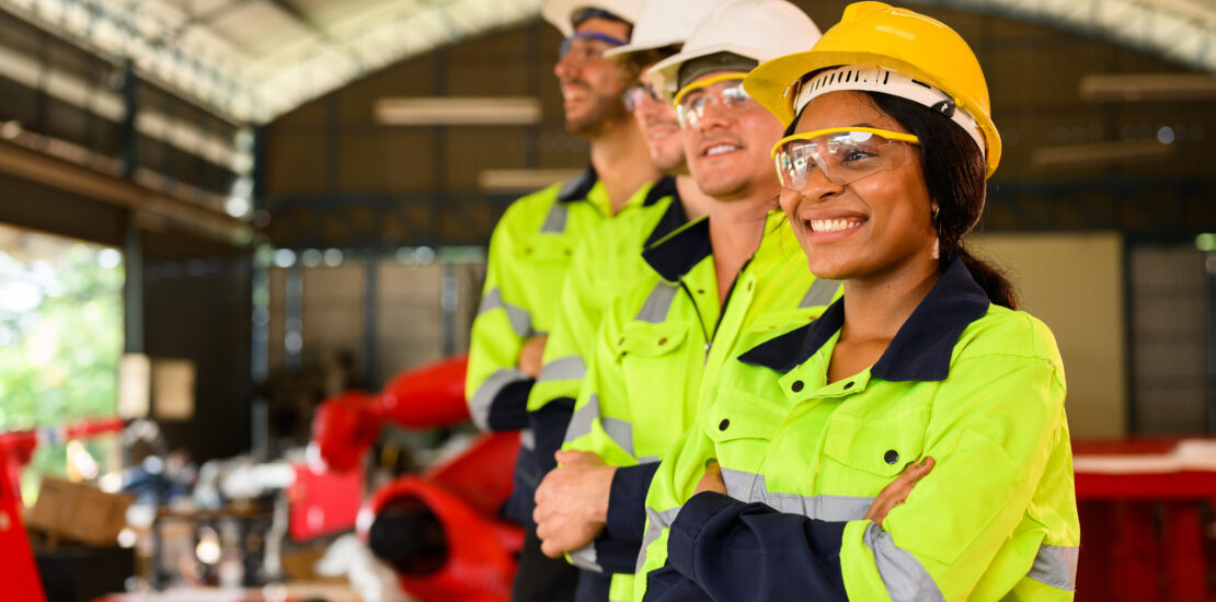 Group Of Technicians Engineers Workers Posing To Camera With Smile